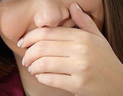 Closeup of person covering mouth
