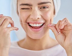 Patient flossing her teeth