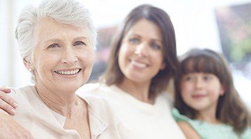 Mother daughter and granddaughter smiling