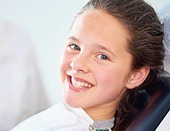 Smiling young girl in dental chair