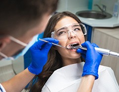 Hygienist removing plaque from a patient’s teeth