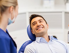Man smiles at dentist
