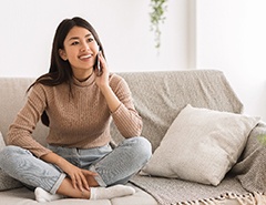smiling person sitting on their couch