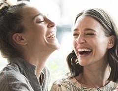 Two young women laughing together