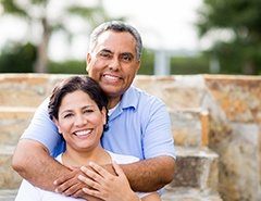 happy couple in front of a brick wall 