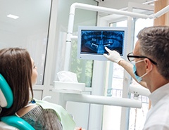 dentist showing a patient their dental X-rays 