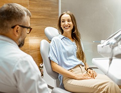 Female patient smiling at dentist at dental appointment