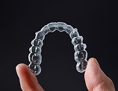 Patient holding clear aligner