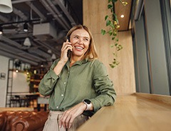 Woman smiling while talking on phone