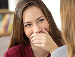 Woman covering mouth