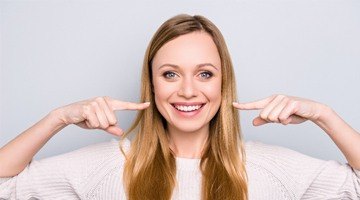 woman smiling pointing