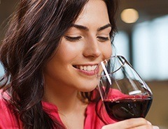 Woman holding glass of red wine