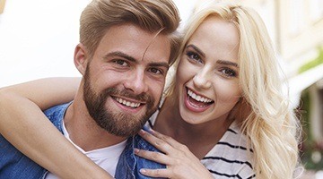 Smiling man and woman outdoors