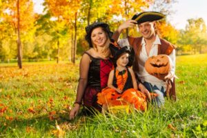 family of three dressed in costumes