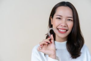 teen girl holding aligner