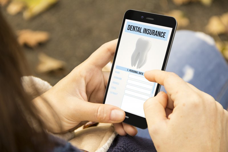 Woman looking at dental insurance benefits on phone