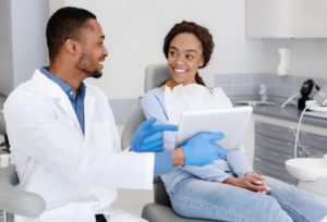 Woman smiles at her Newark dentist during dental checkup