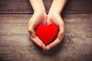 Healthy heart in outstretched hands