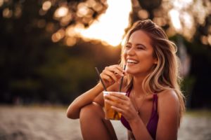 young woman sipping a beverage through a straw 