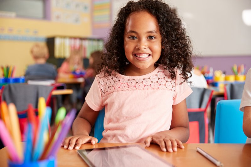 young girl smiling in school