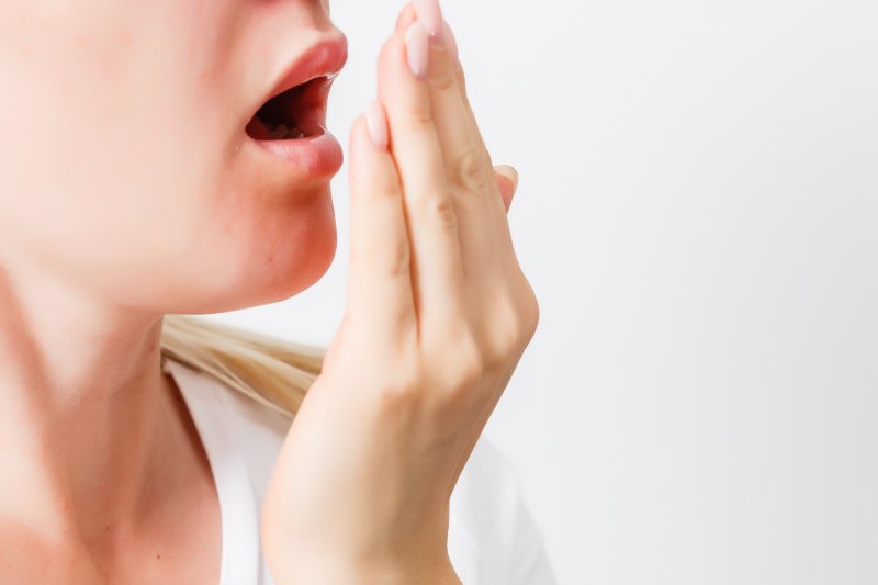 woman checking if she has bad breath in Newark