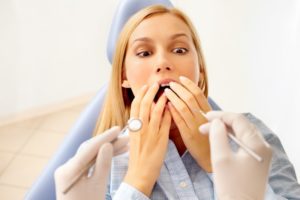 woman looking scared in dental chair 