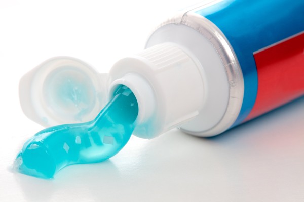 tooth with toothpaste coming out of it