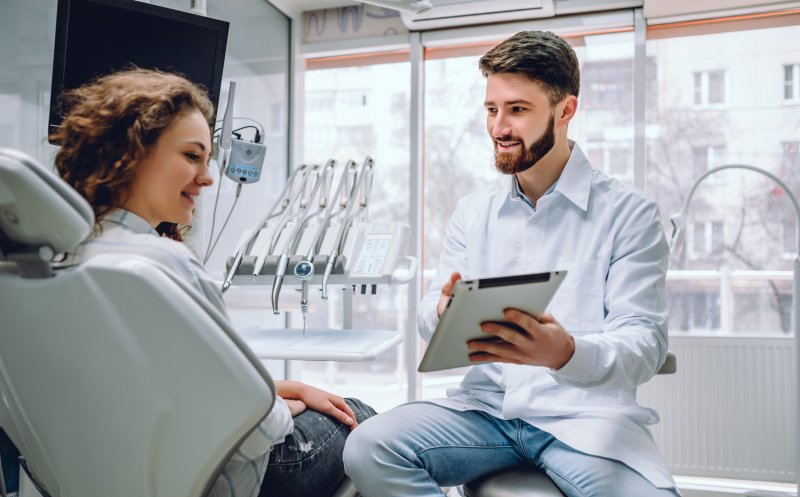 A dentist in Newark explaining dental care tips