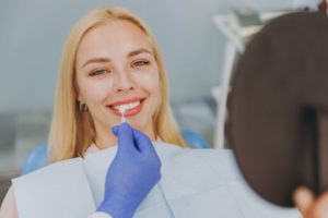 a woman smiling and picking out veneers 