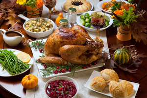 Turkey surrounded by other foods for Thanksgiving