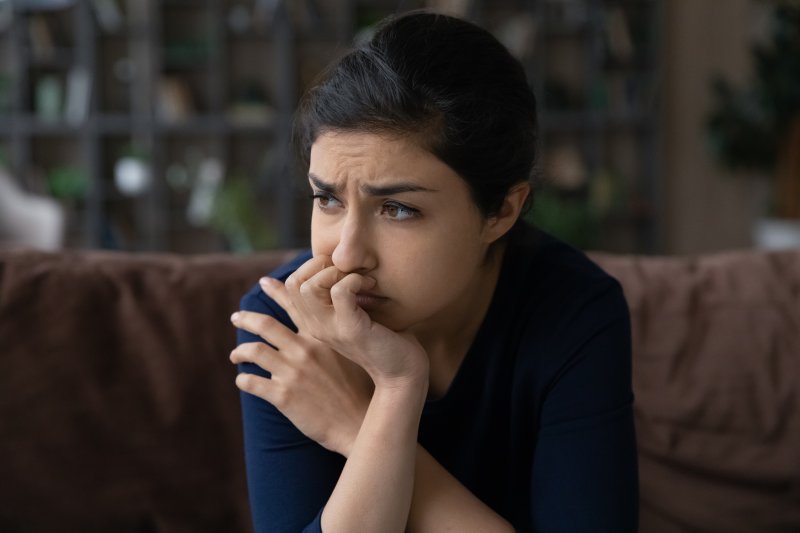 Woman looking depressed about her dental health