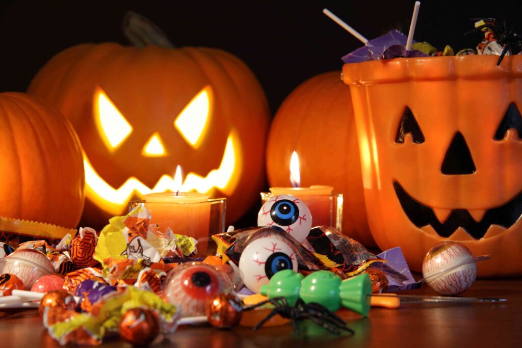 Jack-O-Lantern, candles, and Halloween candy