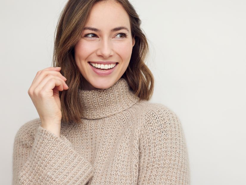 Smiling woman in a beige turtleneck